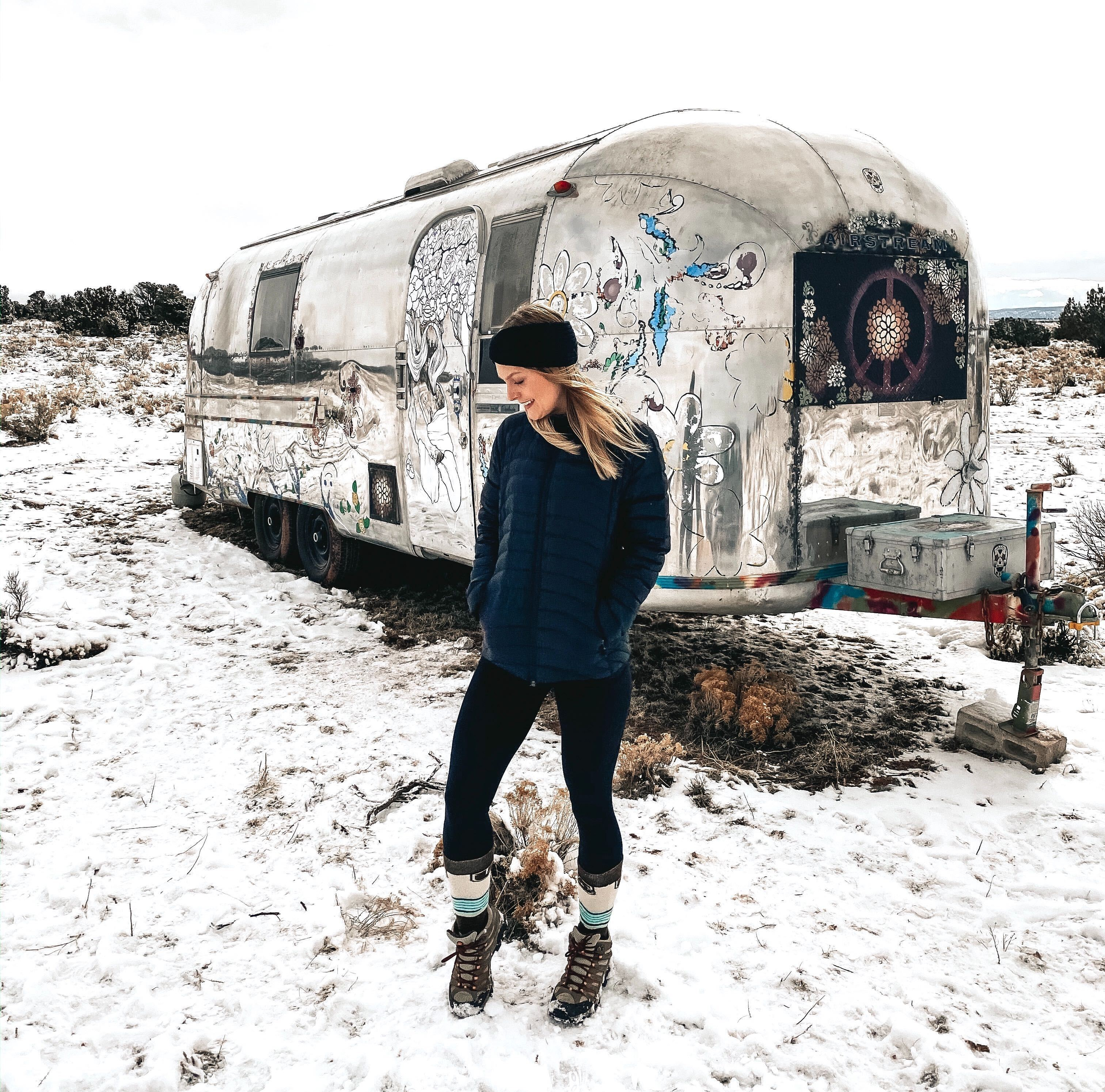 Kay standing in snow outside of an airstream in the Grand Canyon